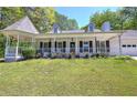 Charming home with a manicured lawn, covered porch, and turret-style gazebo at 105 Whisper Way, Dacula, GA 30019