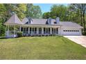 Charming home with a manicured lawn, covered porch, and turret-style gazebo at 105 Whisper Way, Dacula, GA 30019