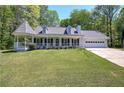 Charming home with a manicured lawn, covered porch, and turret-style gazebo at 105 Whisper Way, Dacula, GA 30019