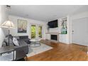 Inviting living room with hardwood floors, fireplace, built-ins, and balcony access, ideal for relaxation at 1150 Collier Nw Rd # A7, Atlanta, GA 30318