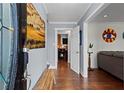 Inviting entryway with hardwood floors, bench and stylish artwork leads into a bright, welcoming home at 2984 Bayard St, East Point, GA 30344