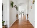 Bright hallway features elegant hardwood floors leading to a living area with decorative plants and art at 2815 Paddle Point Ln, Cumming, GA 30041
