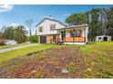 Charming home with stone facade, white siding, and inviting front porch, situated on a partially wooded lot at 10386 Wisteria Ln, Jonesboro, GA 30238