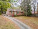 Charming brick house featuring a well-manicured lawn and mature trees, a delightful curb appeal at 1387 Church St, Decatur, GA 30030