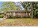 A classic brick house with flowering bushes that enhance the appeal of this lovely home at 1387 Church St, Decatur, GA 30030