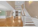 Bright foyer with hardwood floors, staircase and view to the formal living space at 240 River Cove Mdws, Social Circle, GA 30025