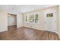 Bright living room with hardwood floors, fresh paint, and large windows providing natural light at 293 Howell Sw Dr, Atlanta, GA 30331