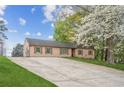 This single-story house features a large driveway and a well-maintained front yard at 140 Apple Valley Dr, Woodstock, GA 30188
