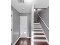 View of the stairway with wood floors on the stairs and gray walls at 2180 Mill Garden Run, Buford, GA 30519