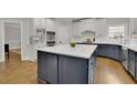 Modern kitchen boasts a large center island, stainless steel appliances, and ample cabinet space at 3022 Woodbridge Ln, Canton, GA 30114