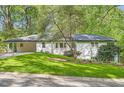 Well-maintained white home with an attached carport and lush green front lawn at 4020 Morgan Rd, Tucker, GA 30084