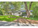 Beautiful white house with an attached carport, set on a lush green lawn with mature trees at 4020 Morgan Rd, Tucker, GA 30084