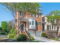 Stunning brick townhouse with a two-car garage, bay window, and a manicured front garden at 5888 Riverstone Cir # 15, Atlanta, GA 30339