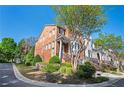 Charming brick townhomes with lush greenery and well-maintained lawns line a quiet neighborhood street at 5888 Riverstone Cir # 15, Atlanta, GA 30339