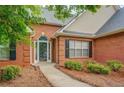 Welcoming front entrance with a white door, sidelights, and a pathway leading to the home at 1917 Kevin Dr, Conyers, GA 30013