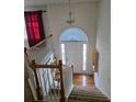 Bright foyer with a white front door and a staircase leading to the upper level at 204 Millpond Pkwy, Villa Rica, GA 30180