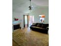 Cozy living room with fireplace, ceiling fan and comfortable dark-colored sofa at 204 Millpond Pkwy, Villa Rica, GA 30180