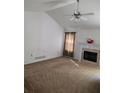 Carpeted living room with a fireplace, ceiling fan, and neutral color palette at 204 Millpond Pkwy, Villa Rica, GA 30180