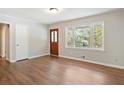 Inviting entryway with beautiful front door, and hardwood floors, next to a large picture window at 2125 Perkerson Mill Rd, Austell, GA 30106