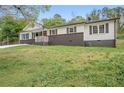 Well-maintained home features a freshly painted exterior, a carport, and mature trees at 2125 Perkerson Mill Rd, Austell, GA 30106