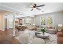Bright open floor plan with hardwood flooring, a modern ceiling fan, and windows providing lots of natural light at 2125 Perkerson Mill Rd, Austell, GA 30106