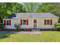 Charming single-story home featuring white siding, red shutters, and a well-manicured lawn at 2488 Glendale Se Cir, Smyrna, GA 30080