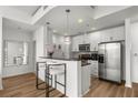 Modern kitchen featuring white cabinetry, stainless steel appliances, and a breakfast bar with seating at 855 Peachtree Ne St # 2706, Atlanta, GA 30308