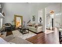 Cozy living room with a fireplace, plush seating, and hardwood floors at 155 Glenside Ln, Duluth, GA 30097