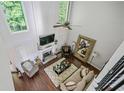 Aerial view of a living room with a fireplace, high ceilings, and hardwood flooring at 155 Glenside Ln, Duluth, GA 30097