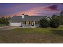 Charming single-story home featuring a welcoming front porch, attached garage, and well-maintained landscaping at 173 Michael Ln, Mcdonough, GA 30252