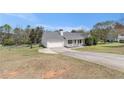 Front lawn and driveway lead up to a well-maintained ranch style house with an attached two-car garage at 173 Michael Ln, Mcdonough, GA 30252