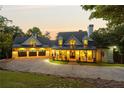 Beautiful exterior of this spacious home with a three car garage and inviting front porch at dusk at 21 Edgewater Se Dr, Cartersville, GA 30121