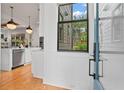 Bright entryway looking into a modern kitchen with stainless steel appliances and hardwood floors at 60 Walthall Ne St # B, Atlanta, GA 30307