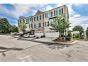 Well-maintained townhome with two car garage and brick exterior, complemented by lush greenery and a well-kept lawn at 125 Sidney St, Marietta, GA 30060
