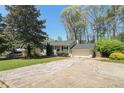 Inviting exterior with attached garage, mature trees, and a spacious front yard, perfect for outdoor activities at 4590 Cedar Ridge Trl, Stone Mountain, GA 30083