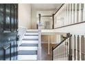 Bright foyer with staircase featuring white railing and grey painted stairs leading to upper and lower levels at 4590 Cedar Ridge Trl, Stone Mountain, GA 30083