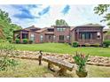 Lush backyard featuring a stone bench, rock garden and covered patio at 5 Northlake Cir # 4 & 5, Peachtree City, GA 30269