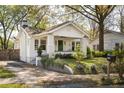 Quaint one-story home with white exterior, well-kept yard, and driveway to the left side at 3120 Church St, Atlanta, GA 30344