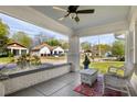 Relaxing front porch view with wicker chair, painted ceiling and a neighborhood street view at 3120 Church St, Atlanta, GA 30344