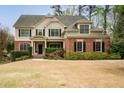 Beautiful two-story home with a brick and siding exterior, black shutters, and mature landscaping at 510 Towneside Ln, Marietta, GA 30064