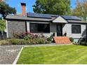 Updated home with fresh landscaping, solar panels and brick entry at 727 Channing Nw Dr, Atlanta, GA 30318