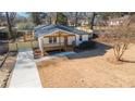 An aerial view of a cozy, freshly renovated home with a charming porch, new driveway, and well-manicured lawn at 984 Manor Se Dr, Smyrna, GA 30080