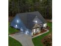 Aerial image showcasing the home's modern design, three car garage and lush landscaping at 174 Vandiver Ct, Acworth, GA 30101