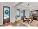 Elegant dining room featuring hardwood floors, coffered ceilings and modern light fixture at 174 Vandiver Ct, Acworth, GA 30101