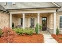 Inviting front porch with stone flooring, rocking chairs, and charming curb appeal at 174 Vandiver Ct, Acworth, GA 30101
