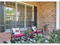 Charming front porch with rocking chairs, decorative pillows, and potted plants, perfect for relaxing outdoors at 205 Northampton Ct, Canton, GA 30115