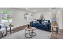 Bright living room boasts new floors, fresh paint, and an abundance of natural light from large windows overlooking the yard at 2831 Ivanhoe Se Ln, Smyrna, GA 30082