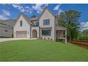 Charming two-story house with a manicured lawn, attractive brickwork, and a cozy front porch at 380 Hillcrest View Dr, Suwanee, GA 30024