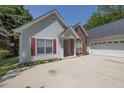 Charming single-Gathering home with an attached two-car garage and manicured flowerbeds at 1635 Round Rd, Grayson, GA 30017