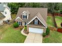 Aerial view of a well-manicured front yard leading up to a charming brick home at 272 William Nye Se Dr, Atlanta, GA 30315